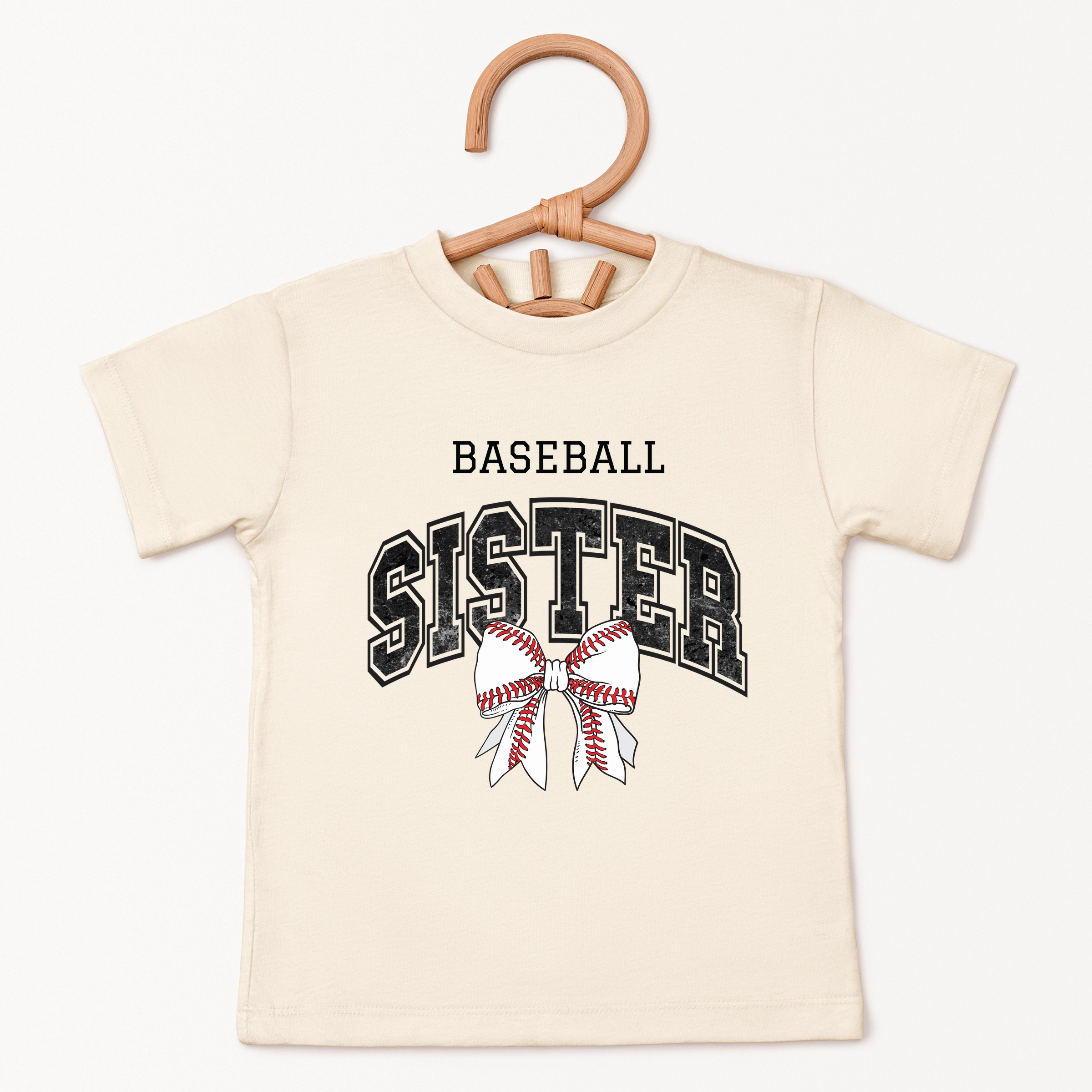 The Juniper Shop - Baseball Sister Varsity Coquette Toddler Short Sleeve Graphic T-Shirt