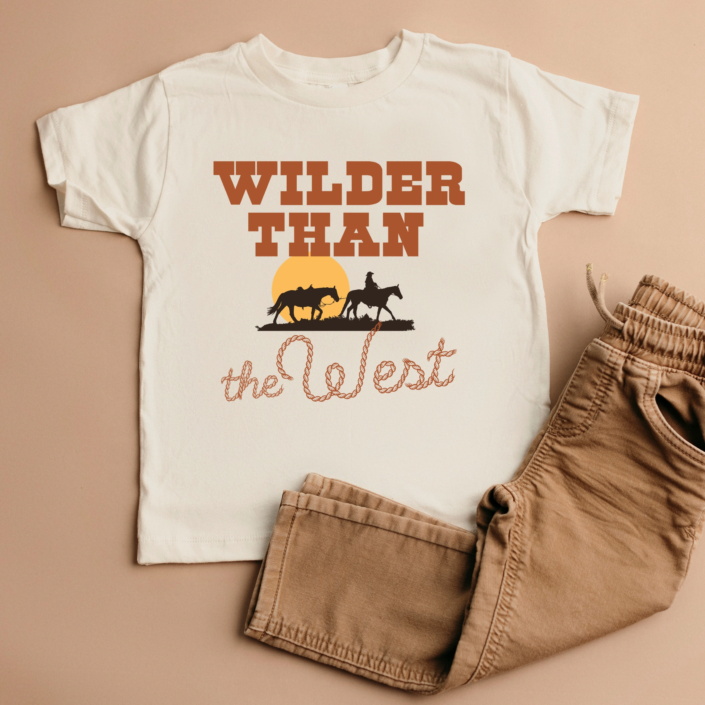 The Juniper Shop - Wilder Than West Bold Toddler Short Sleeve Graphic T-Shirt