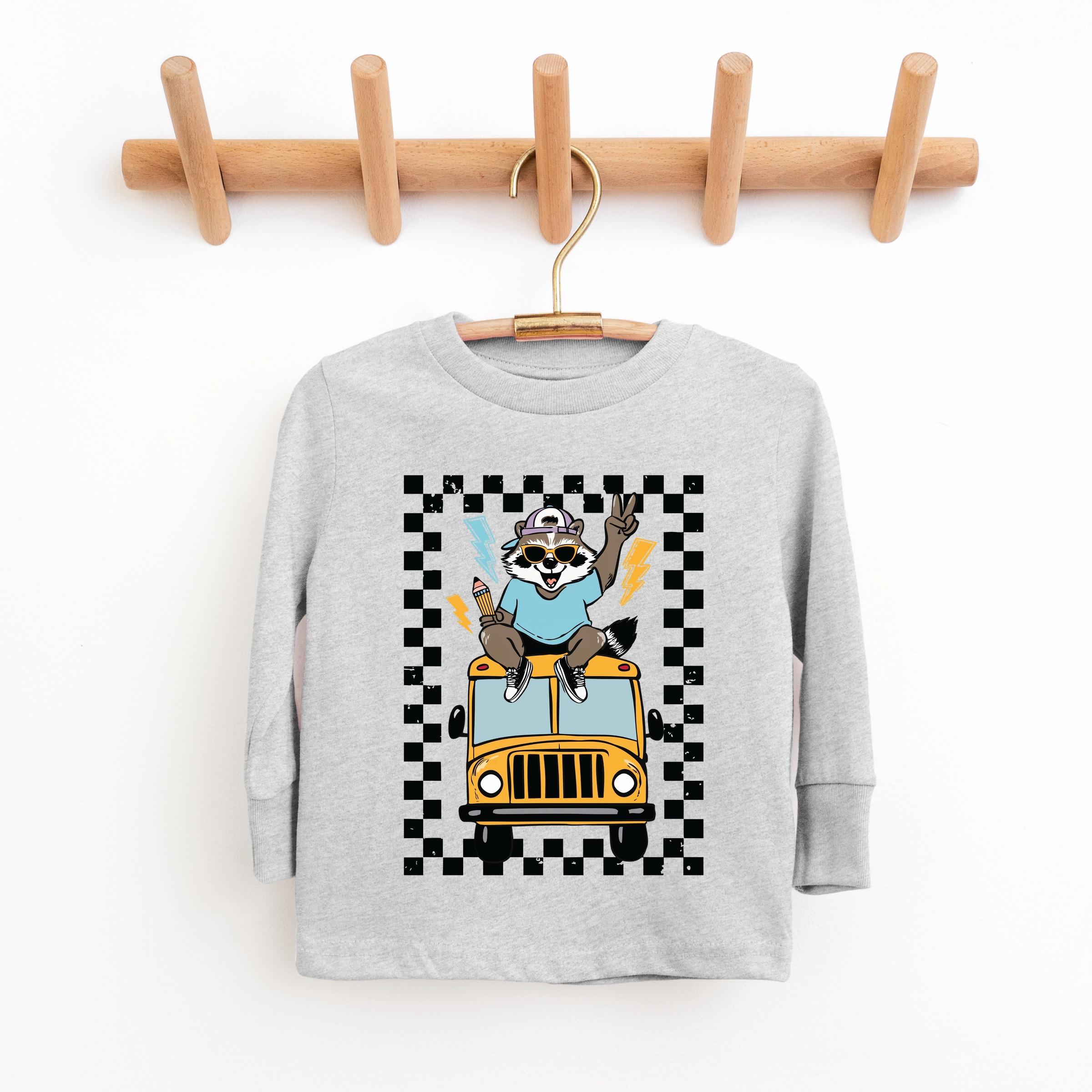 The Juniper Shop - Youth Long Sleeve Graphic T-Shirt Racoon School Bus Lightning