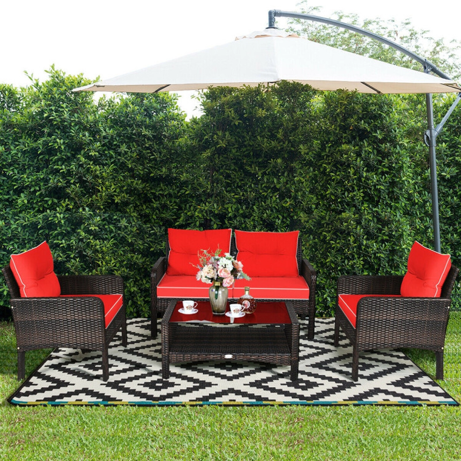 SUGIFT 4-Piece 800-lb Loveseat Capacity Red Rattan Wicker Patio Furniture Set with Glass Storage Table