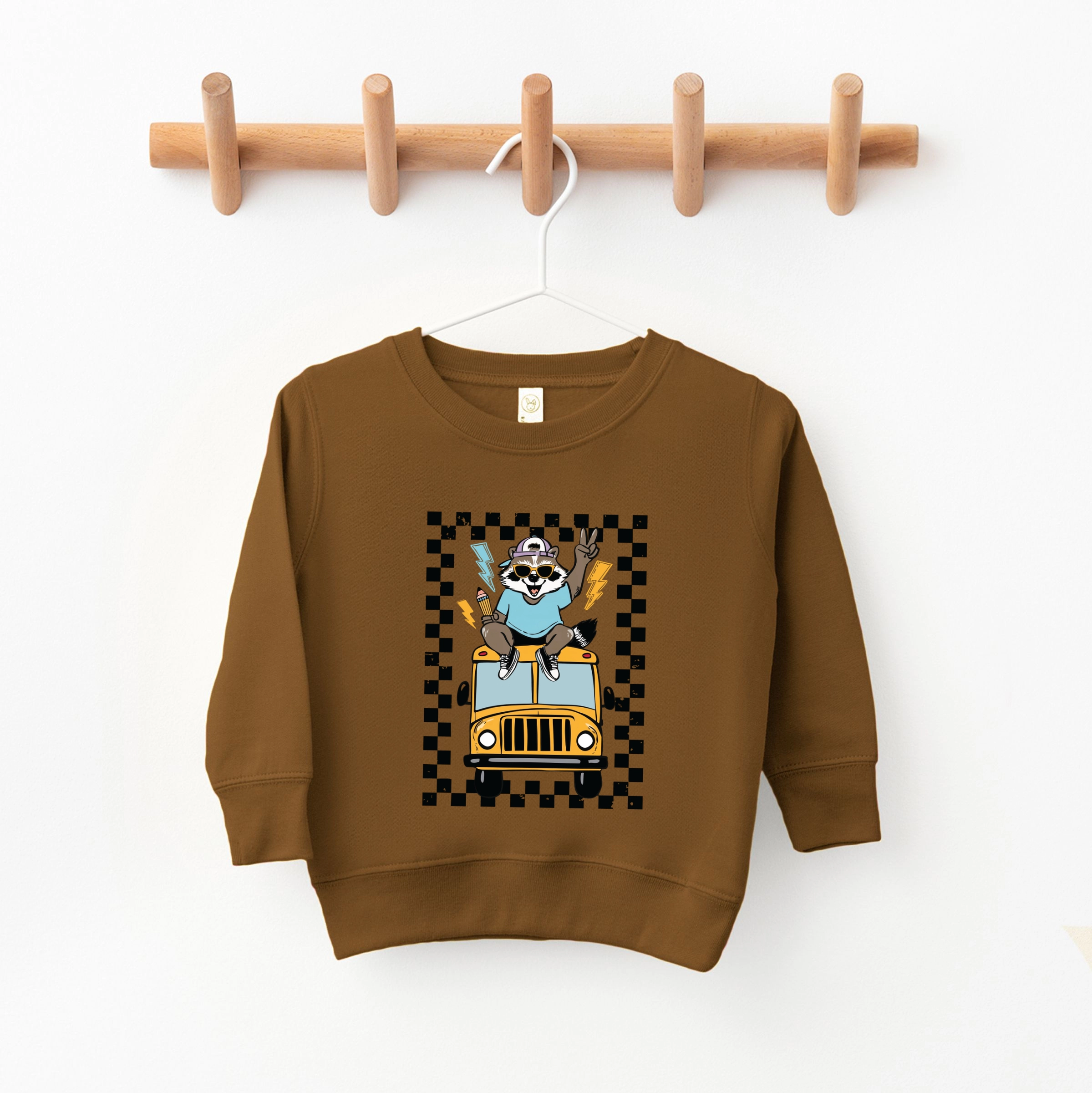 The Juniper Shop - Youth Graphic Sweatshirt Racoon School Bus Lightning
